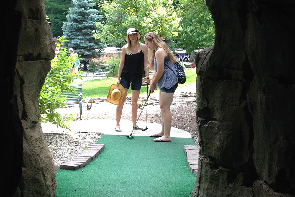Guests Playing Miniature Golf In Cave